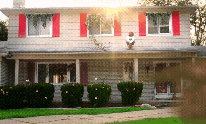 a man standing on the roof of a house