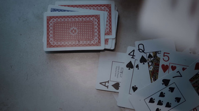 a table topped with playing cards and playing cards