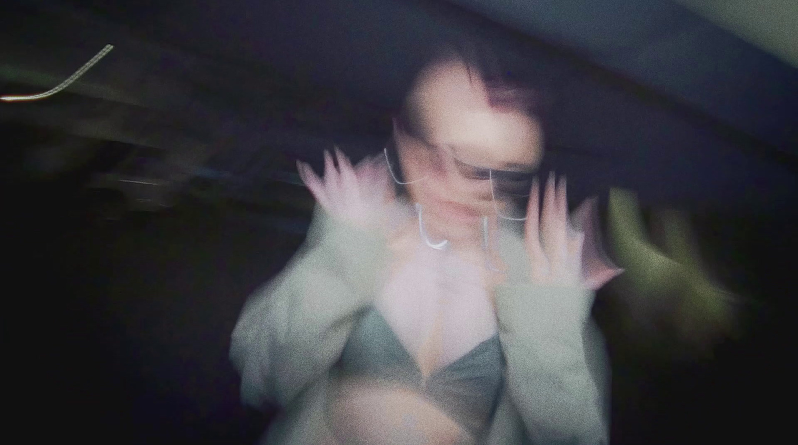 a blurry photo of a woman with her hands in the air