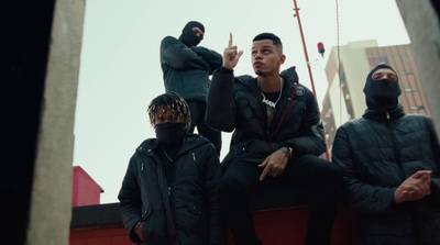 a group of men sitting on top of a building