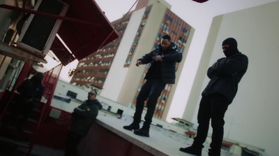 a group of men standing on top of a roof