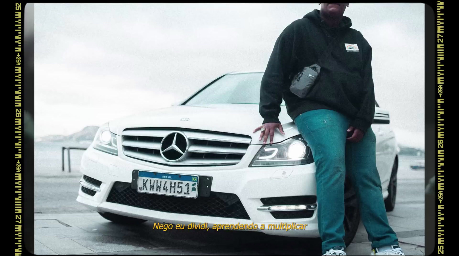 a man standing next to a white car