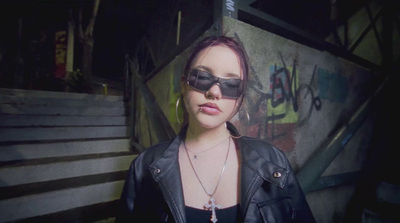 a woman wearing sunglasses and a leather jacket