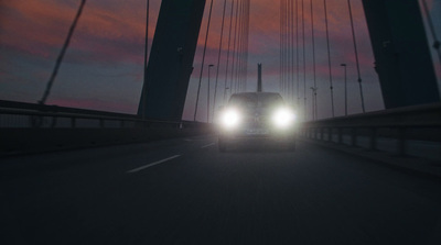 a car driving across a bridge at night