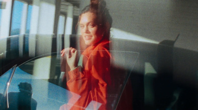 a woman standing in front of a glass table