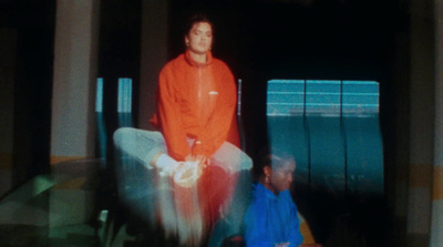 a man sitting on a chair in front of a tv