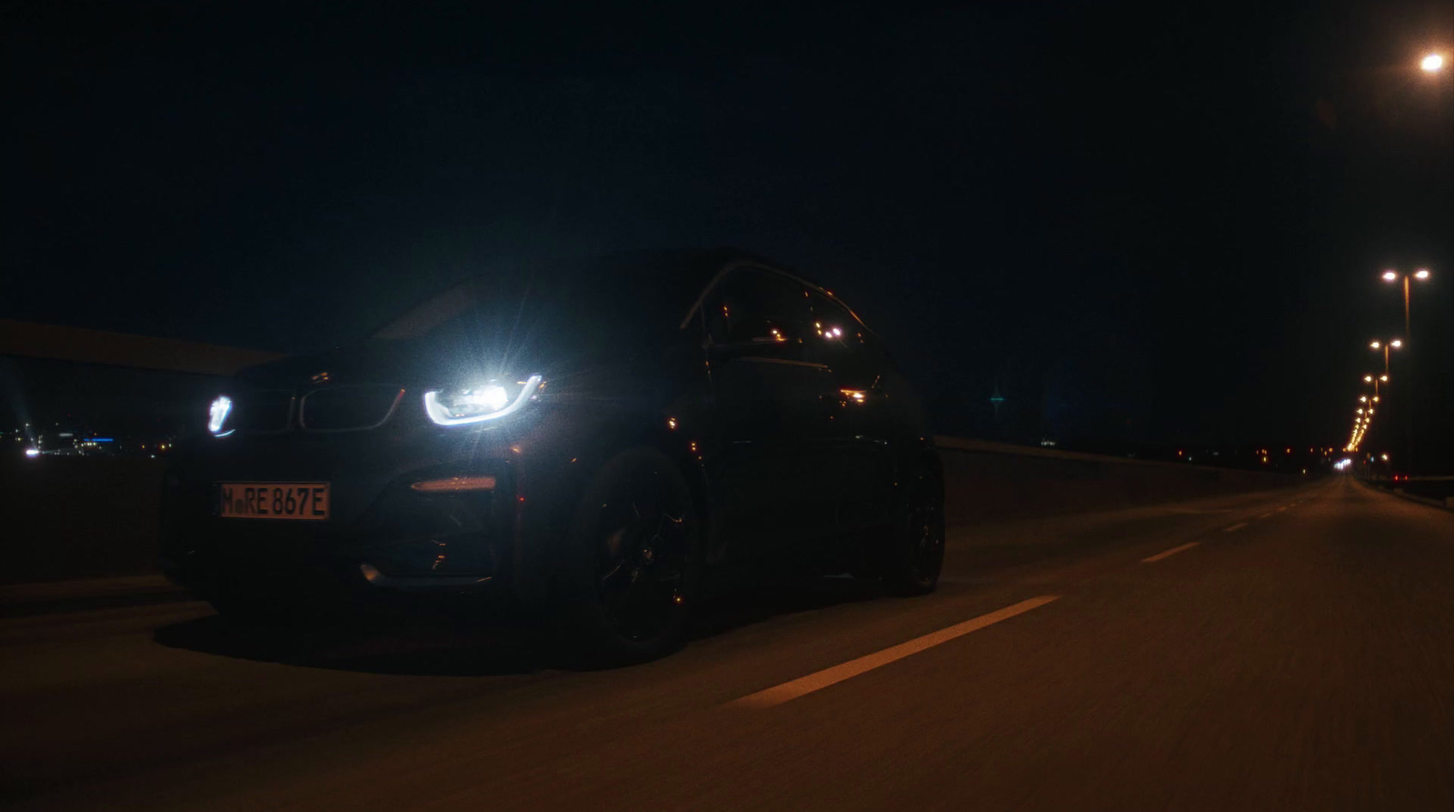 a car driving down a road at night