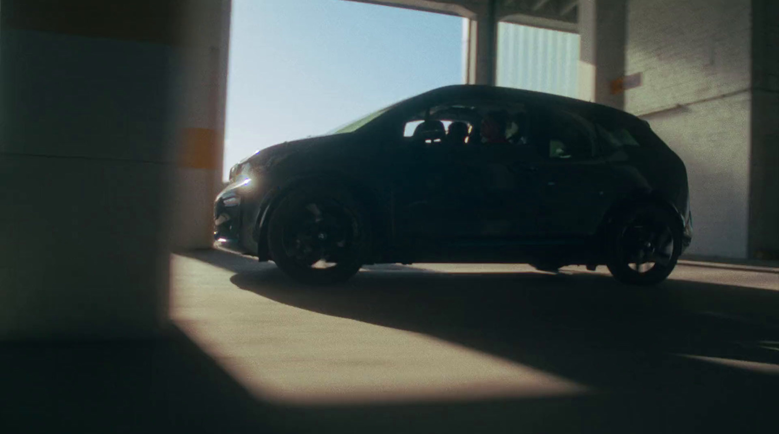 a small black car parked in a garage