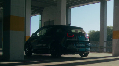 a blue car parked in a parking garage