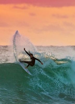 a man riding a wave on top of a surfboard