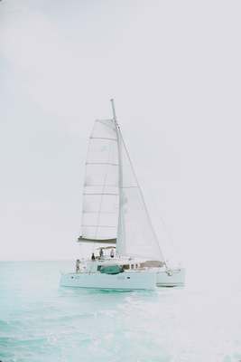 a sailboat sailing in the ocean on a cloudy day