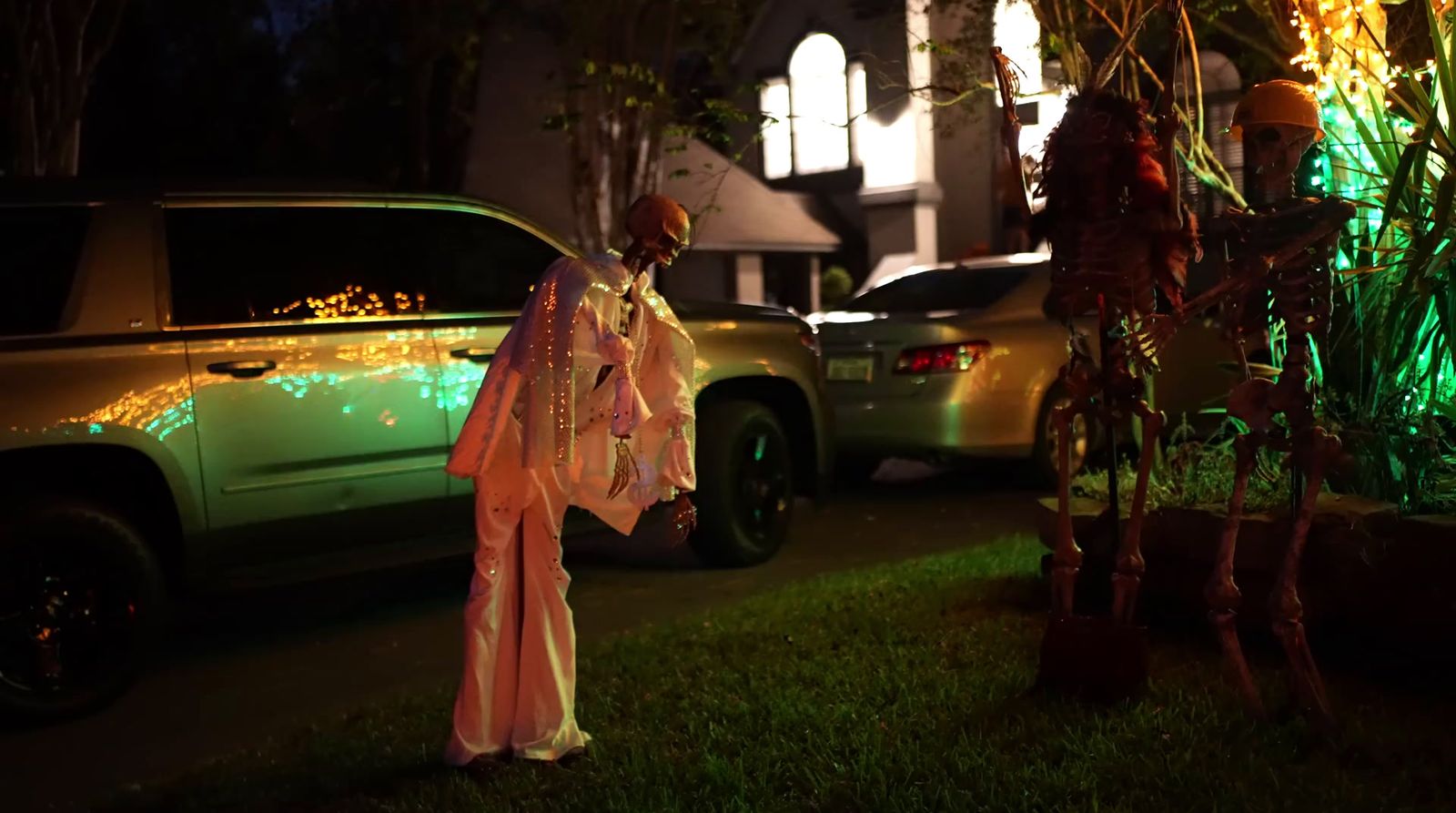 a woman dressed in a costume standing next to a car