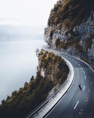 a person riding a motorcycle on the side of a road