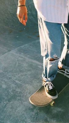 a person riding a skateboard on a cement surface