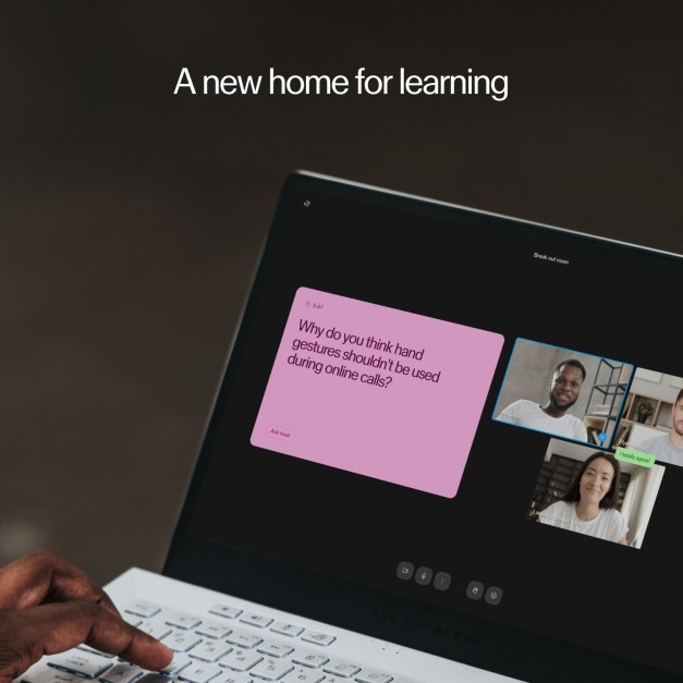 a person using a laptop with a pink sticker on it