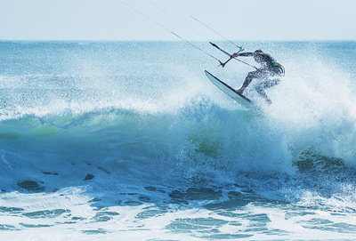 a man riding a wave on top of a surfboard