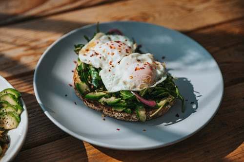 two plates of food on a wooden table