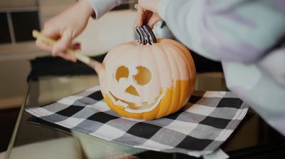 a person carving a pumpkin with a knife