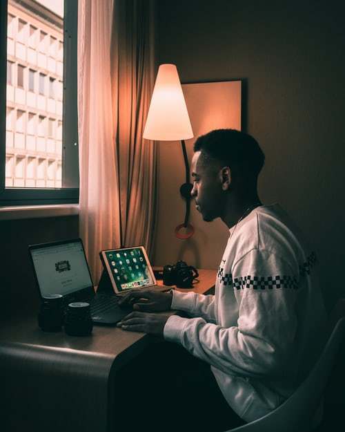 a man sitting in front of a laptop computer