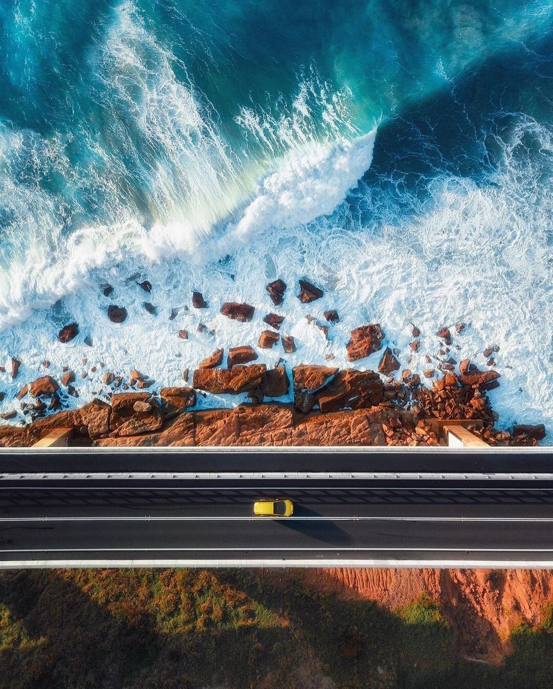 an aerial view of a highway near the ocean