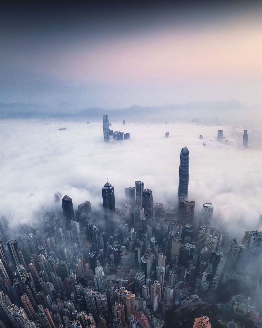 a view of a city in the middle of a foggy day