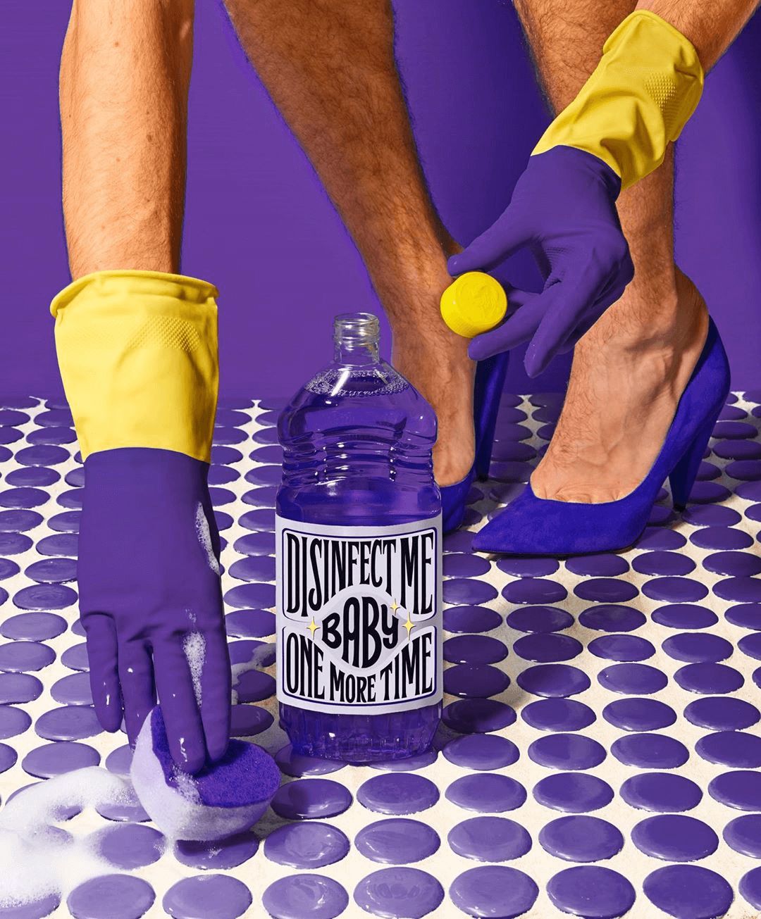 a person in purple gloves and yellow gloves cleaning a table