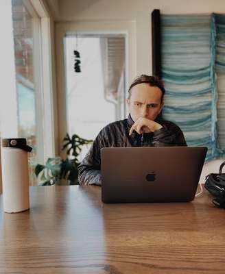 a man sitting in front of a laptop computer