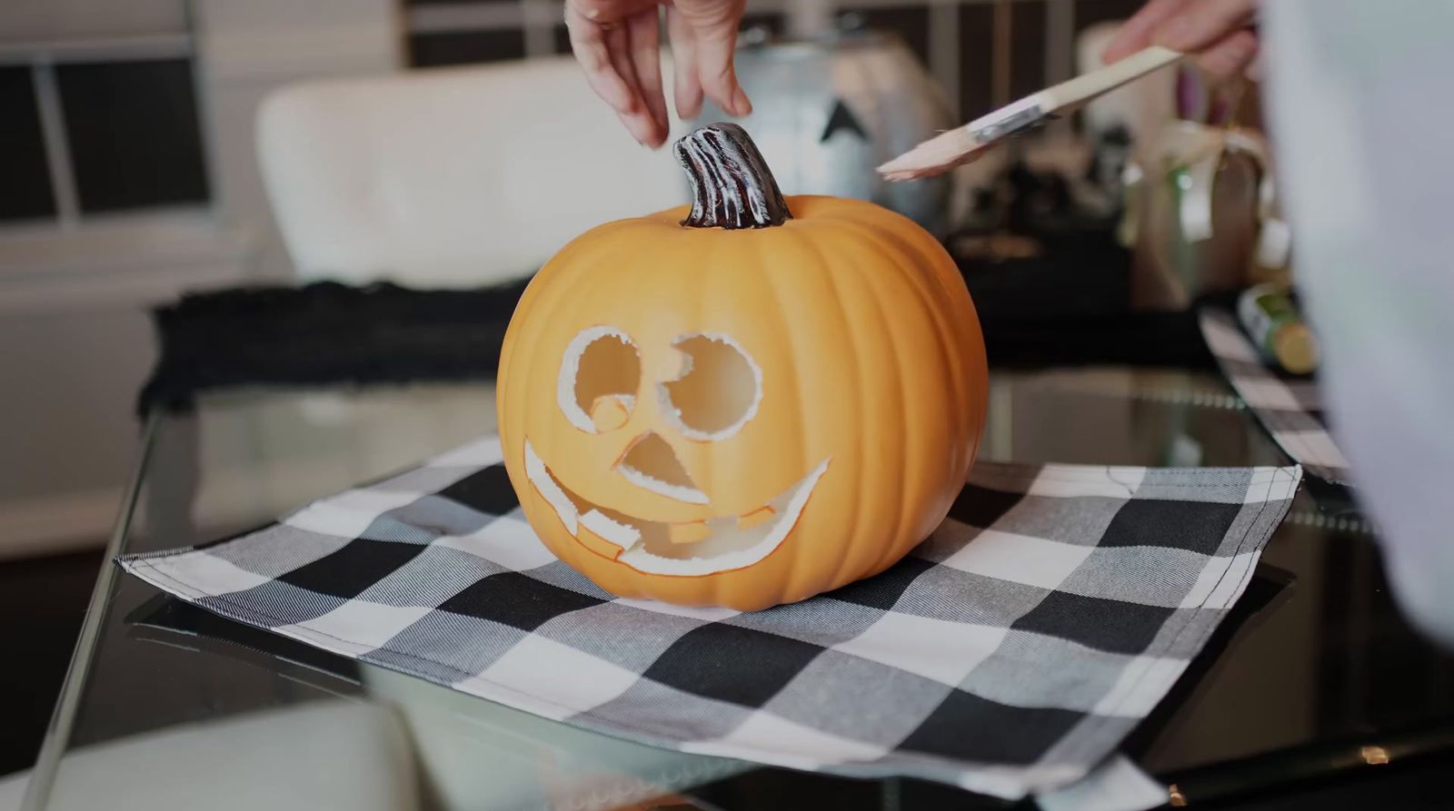 a person carving a pumpkin with a knife