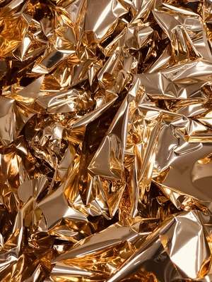 a pile of gold foil sitting on top of a table