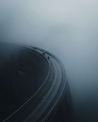 a car driving down a road in the fog