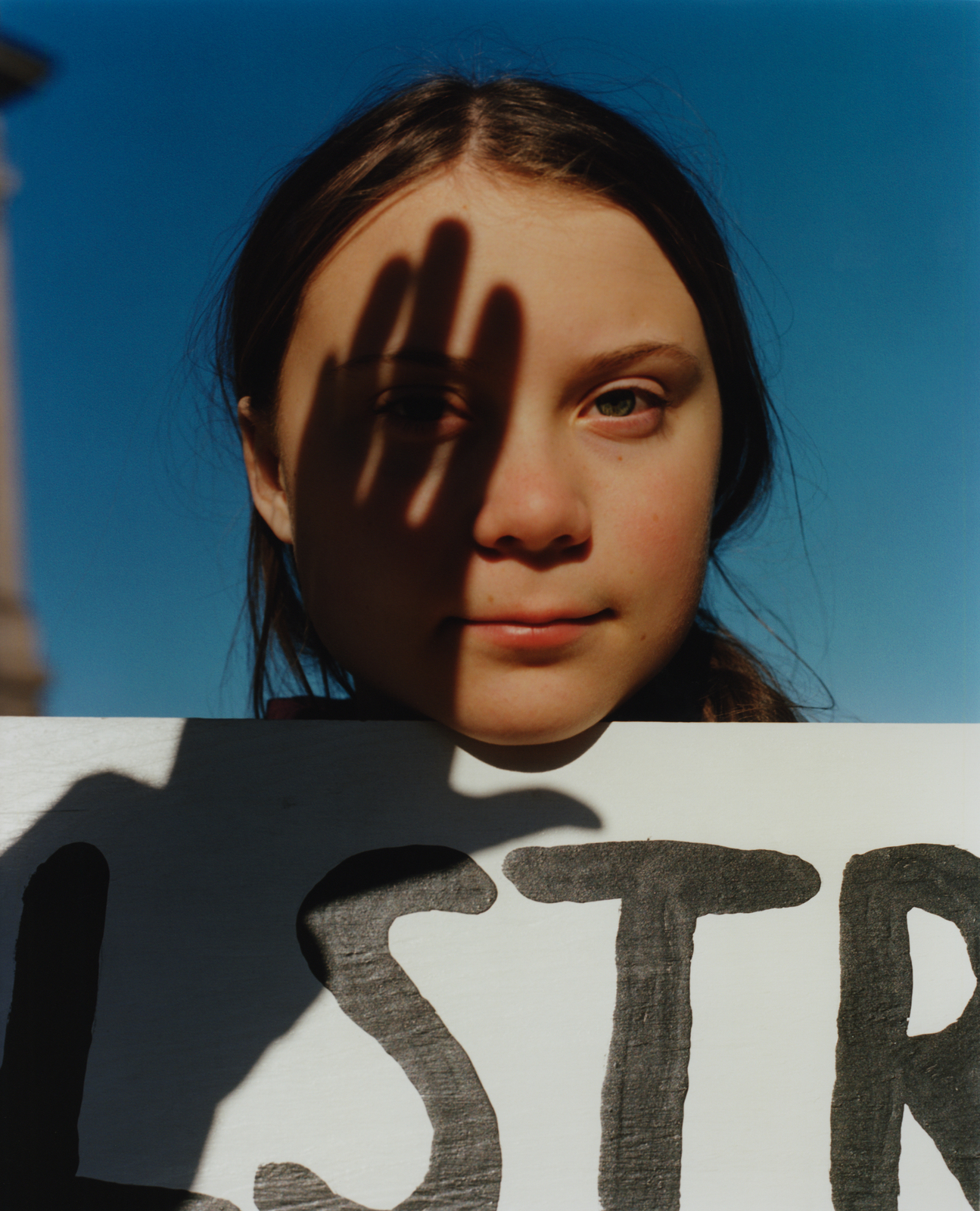 a young girl holding a sign with the word star painted on it