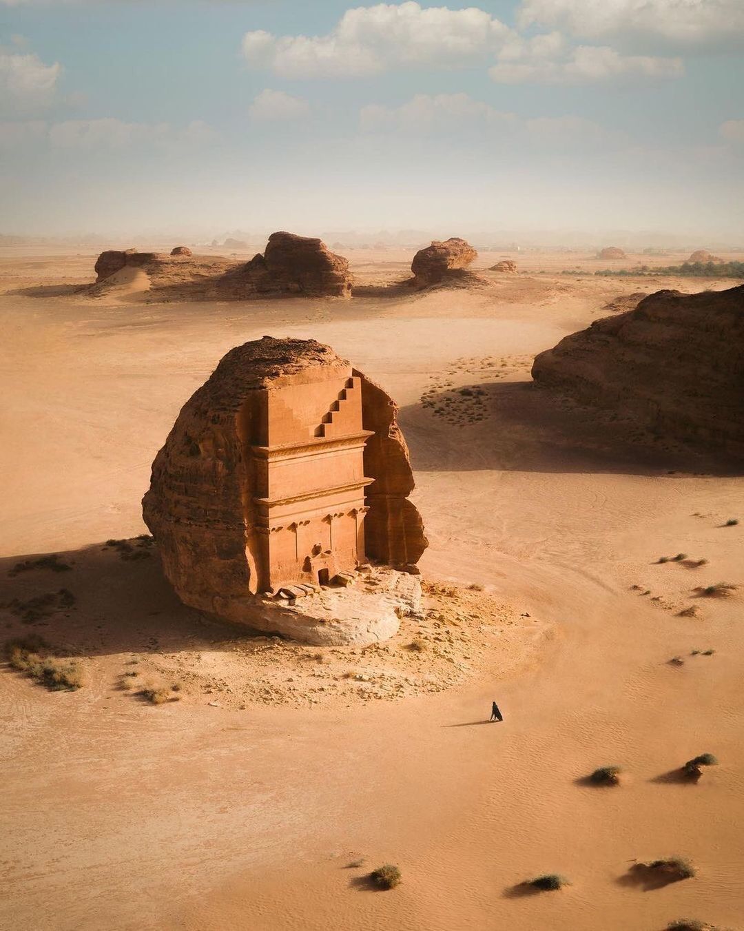 a small building in the middle of a desert