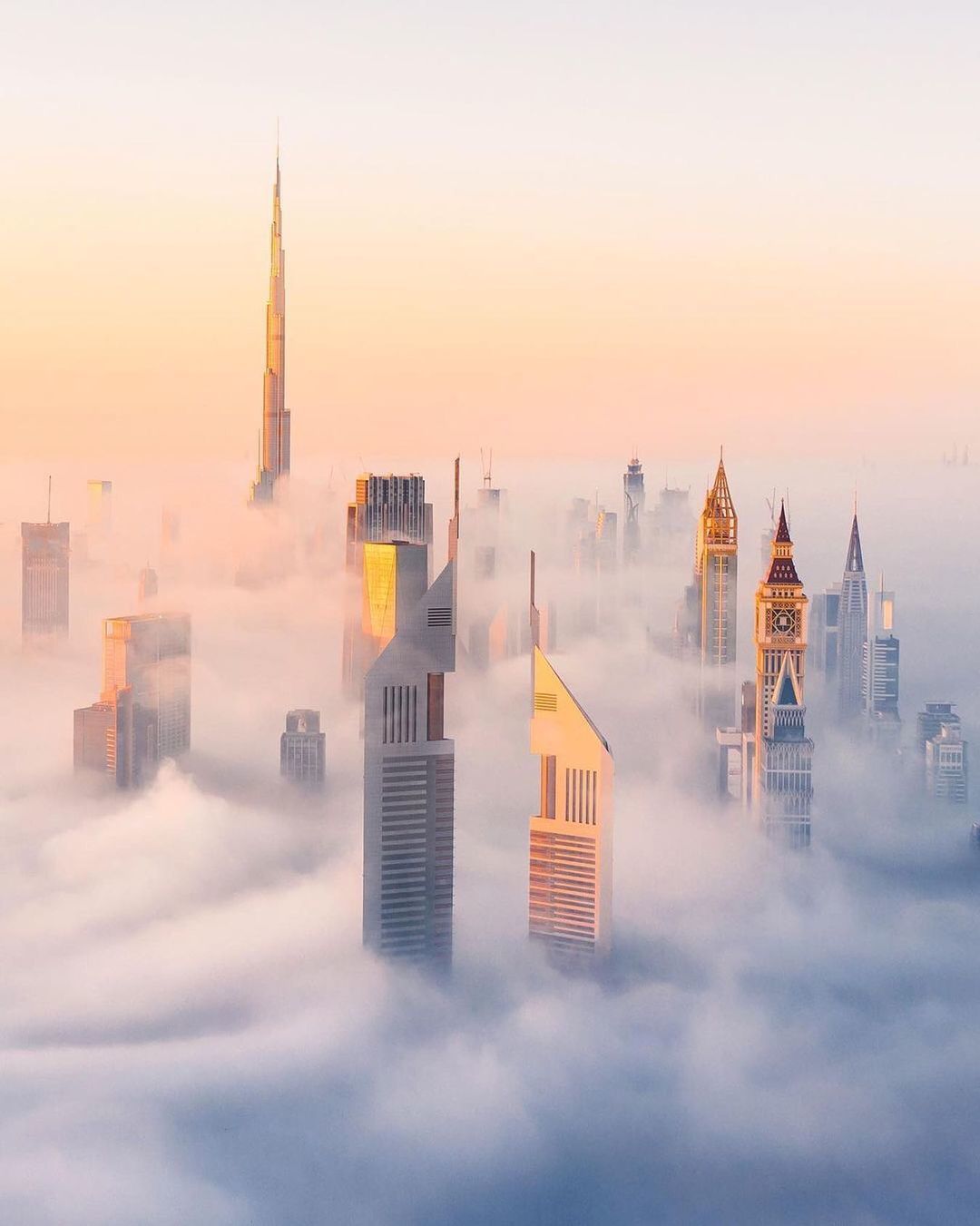 a view of a city in the middle of a foggy day