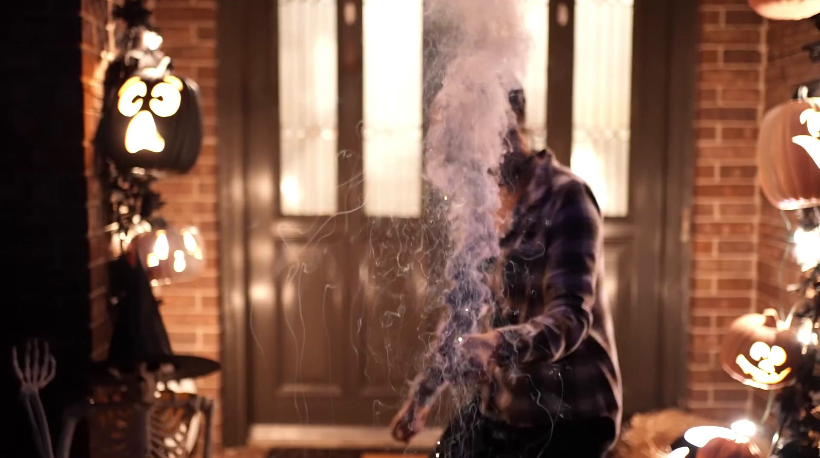 a person standing in front of a door with smoke coming out of it