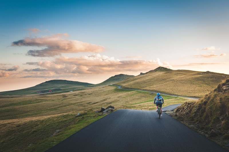 a person riding a bike down a road