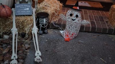 a couple of halloween decorations sitting on top of a sidewalk