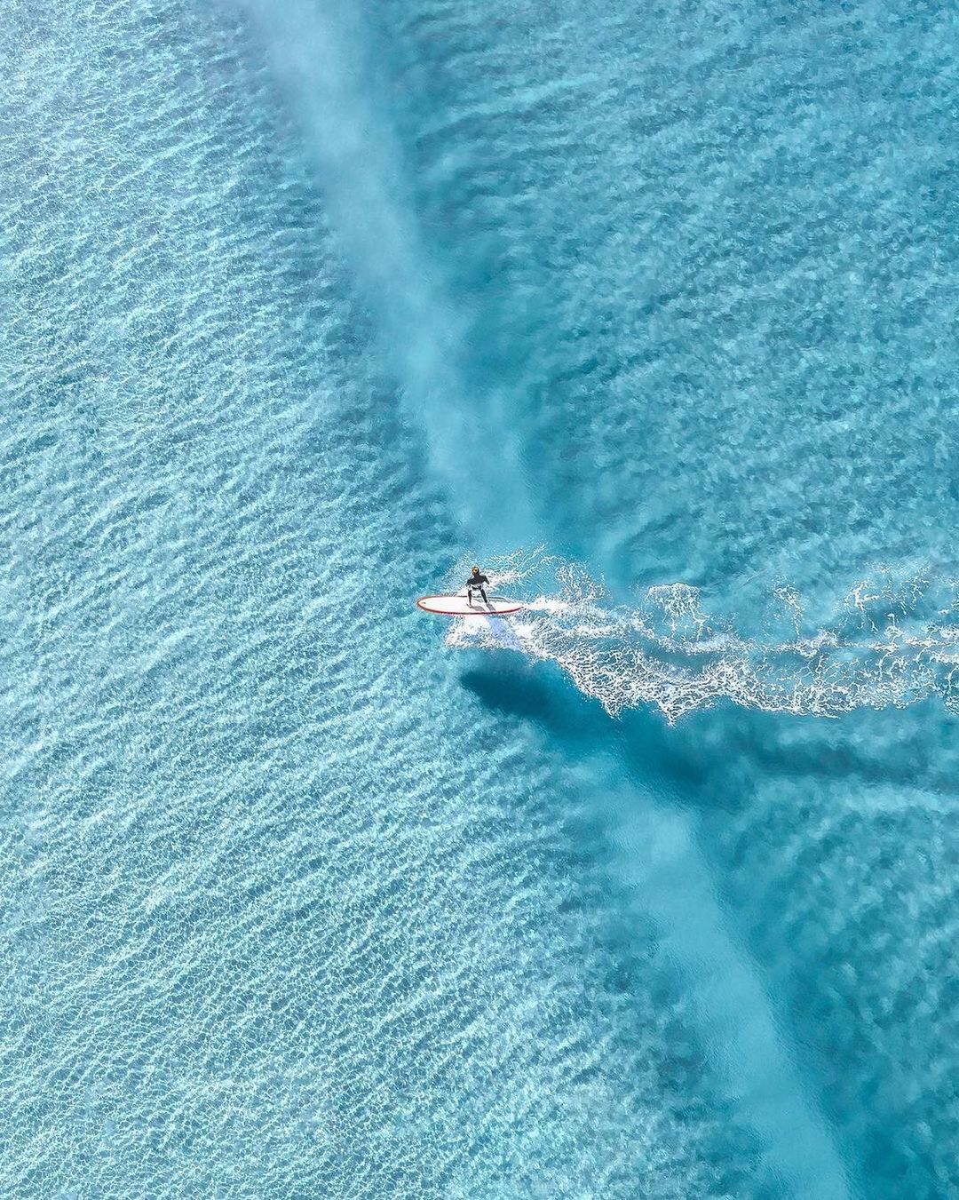 a person riding a surf board on a body of water