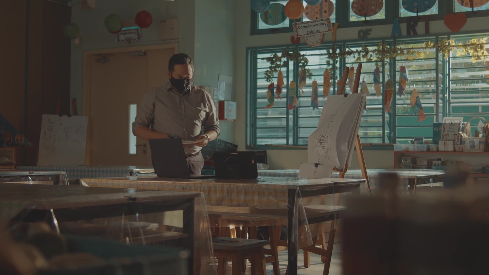 a man standing in front of a laptop computer