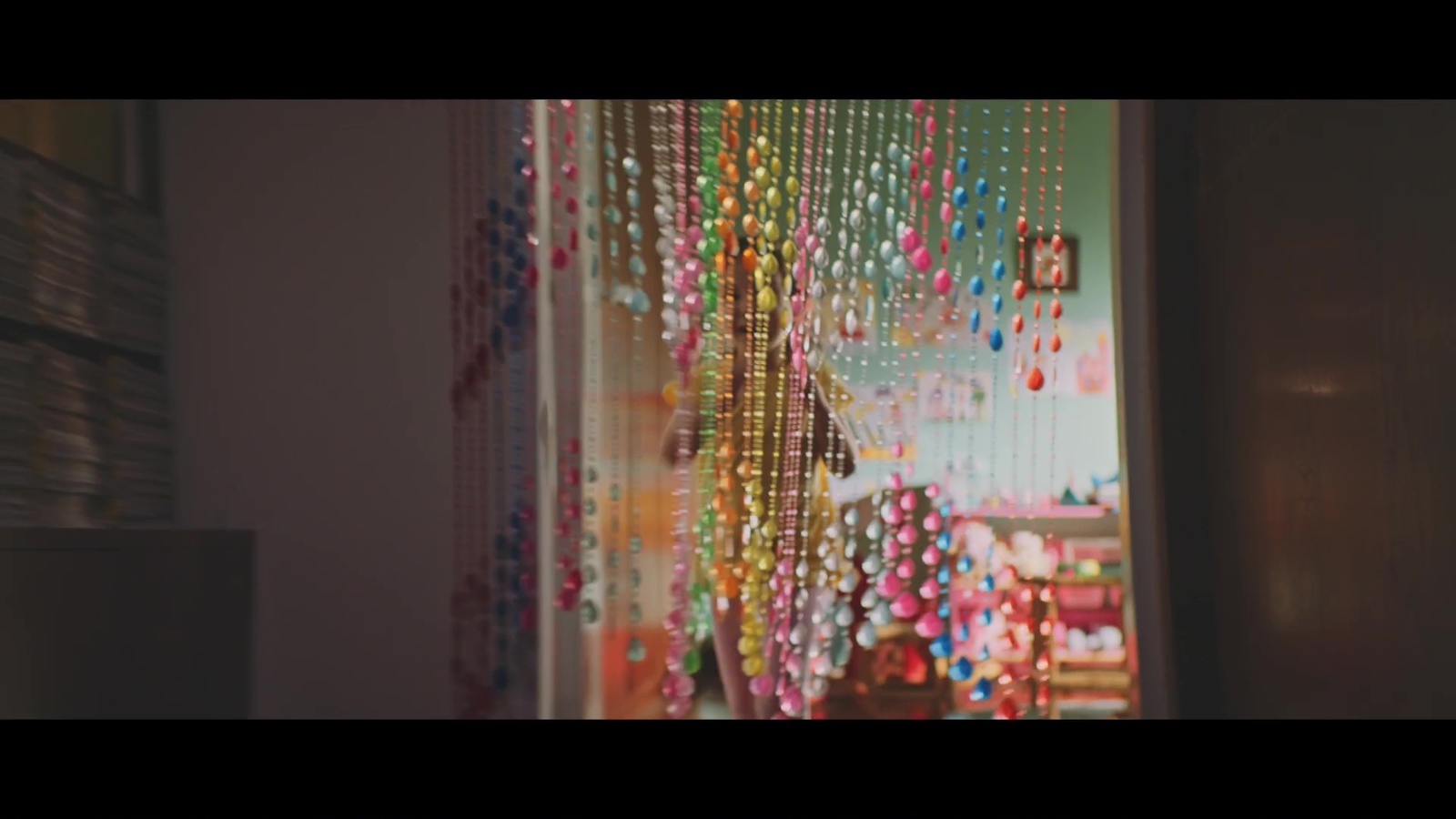 a room with a bunch of beads hanging from the ceiling