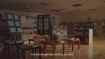 a room filled with lots of books and tables