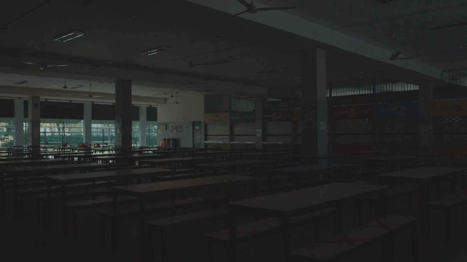 an empty classroom with desks and windows