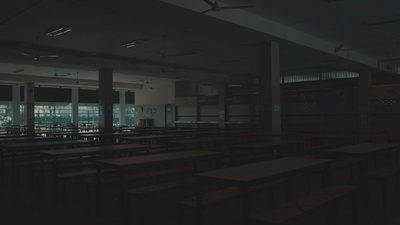 an empty classroom with desks and windows