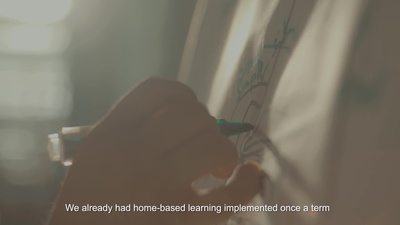 a person writing on a whiteboard with a marker