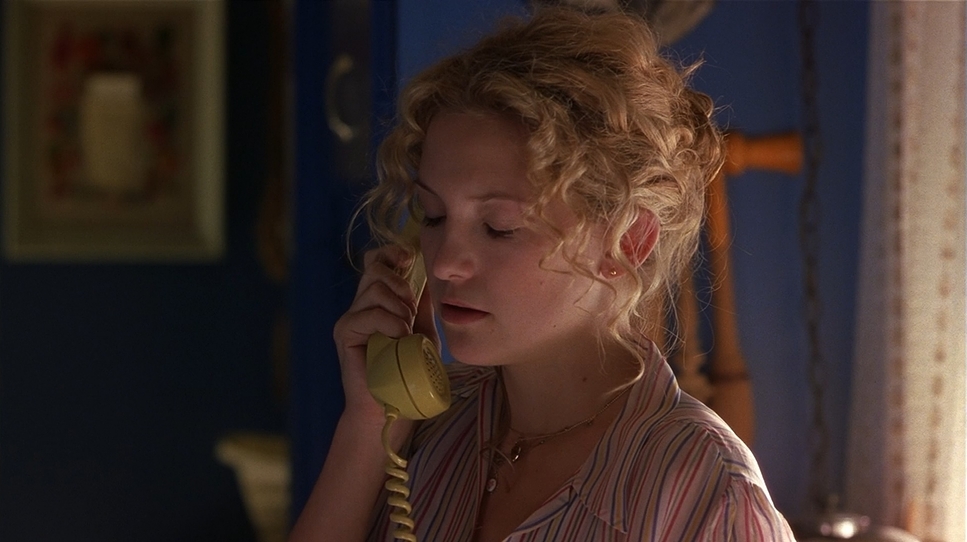 a woman talking on a phone in a room