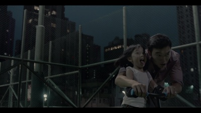 a man riding a bike next to a little girl