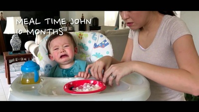 a woman feeding a baby in a high chair