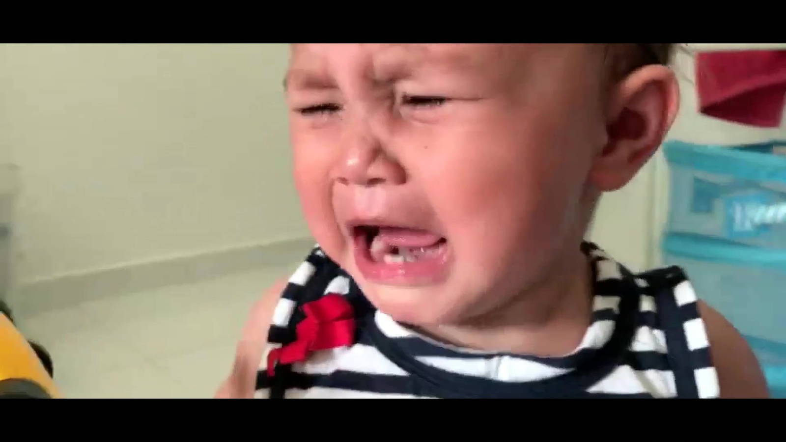 a little boy that is crying in a bathroom