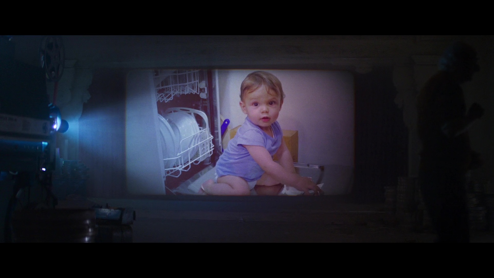 a small child sitting on the floor in front of a tv