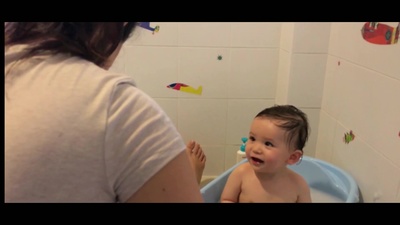 a baby sitting in a blue potty in a bathroom