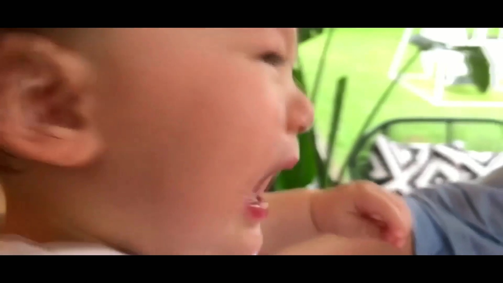 a little boy that is sitting down with his mouth open